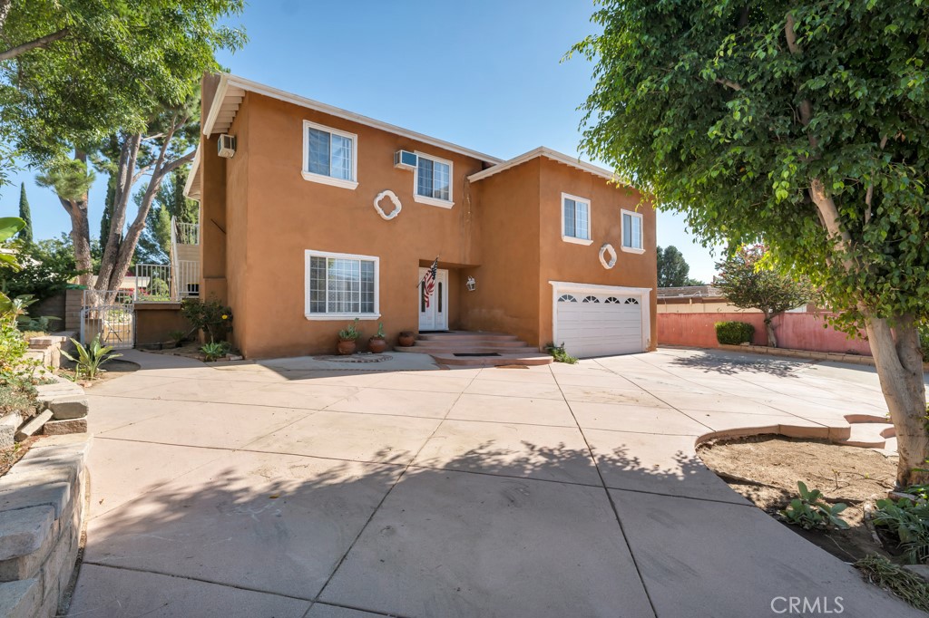 14024 Tyler Street Sylmar, CA 91342 - Photo 4 of 50 a front view of a house with a yard