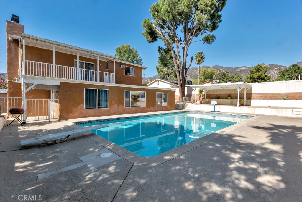 14024 Tyler Street Sylmar, CA 91342 - Photo 5 of 50 a view of a swimming pool with a lounge chairs