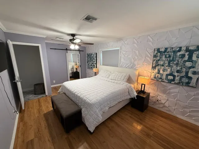 a bed sitting in a bedroom next to a window