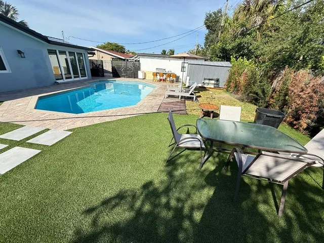 a view of a patio with chairs and a yard