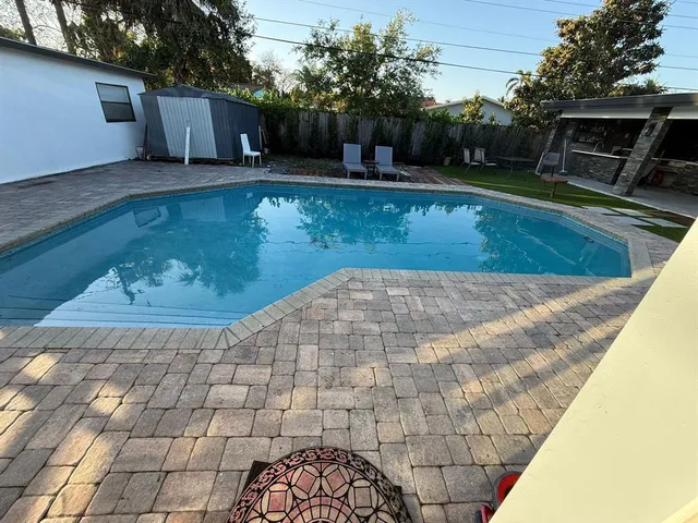 a bedroom with a bed mirror and a window