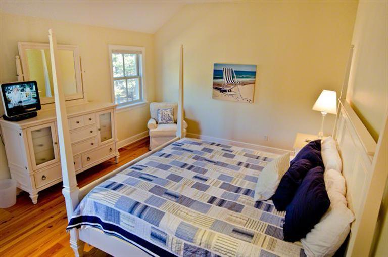 4 Magnolia Way Edgartown, MA 02539 - Photo 13 of 23 a bedroom with a bed and flat tv screen on the dresser
