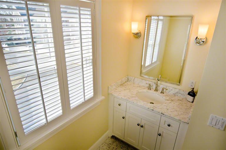4 Magnolia Way Edgartown, MA 02539 - Photo 17 of 23 a bathroom with a granite countertop sink and a window