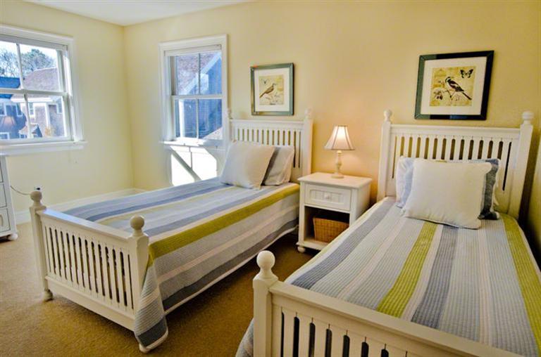 4 Magnolia Way Edgartown, MA 02539 - Photo 18 of 23 a bedroom with two beds and a wooden floor
