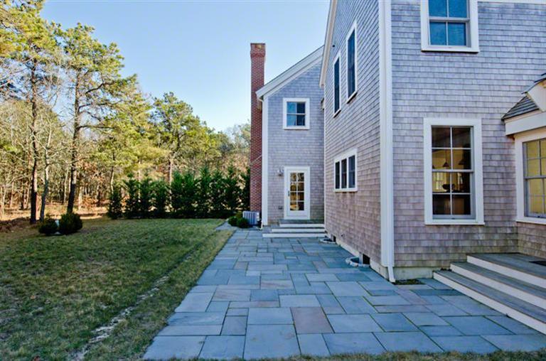 4 Magnolia Way Edgartown, MA 02539 - Photo 2 of 23 a view of a brick house with a yard and large trees