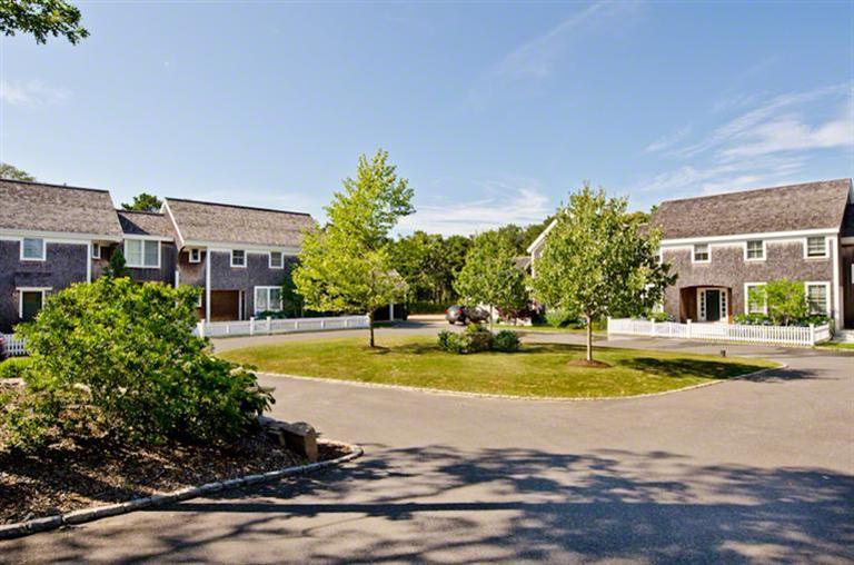 4 Magnolia Way Edgartown, MA 02539 - Photo 21 of 23 a view of a swimming pool with a house in the background
