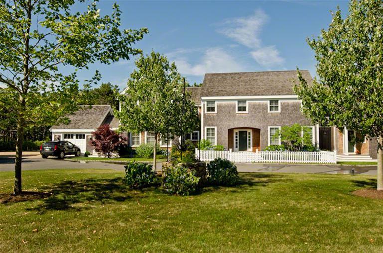 4 Magnolia Way Edgartown, MA 02539 - Photo 22 of 23 a front view of a house with a garden