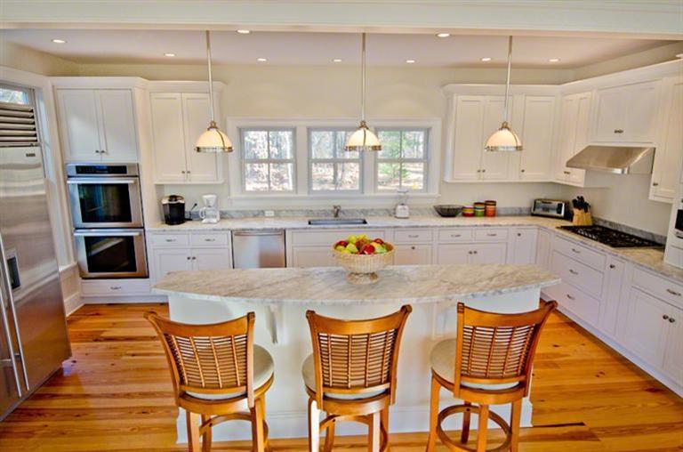 4 Magnolia Way Edgartown, MA 02539 - Photo 8 of 23 a large kitchen with a table and chairs