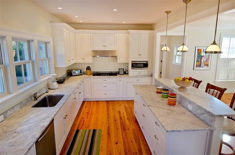 4 Magnolia Way Edgartown, MA 02539 - Photo 9 of 23 a large kitchen with stainless steel appliances granite countertop a sink a stove and a wooden floors