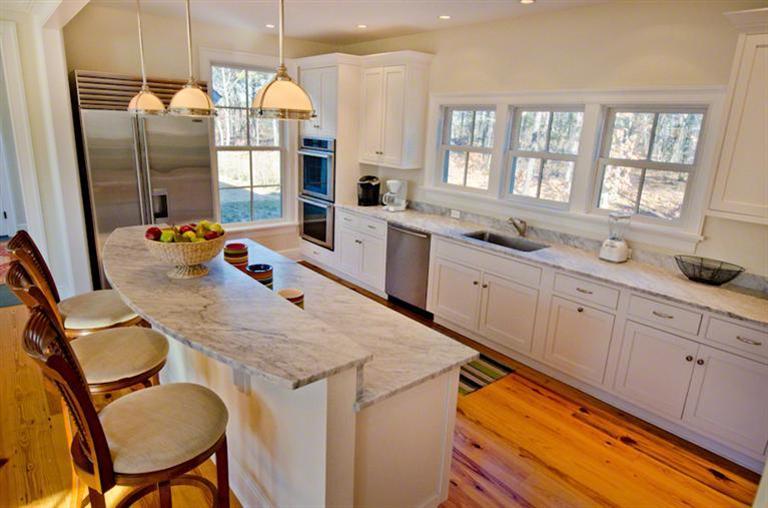 4 Magnolia Way Edgartown, MA 02539 - Photo 10 of 23 a kitchen that has a sink a stove and chairs