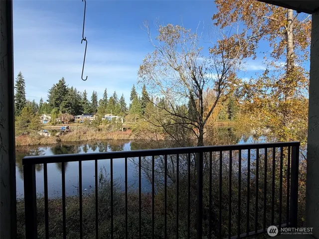 a view of a balcony with wooden fence
