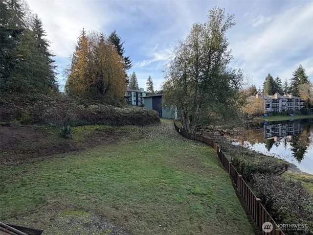 a view of a street with a yard and plants