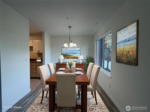 a dining room with furniture window and wooden floor