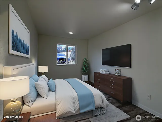 a bedroom with a bed and a flat screen tv