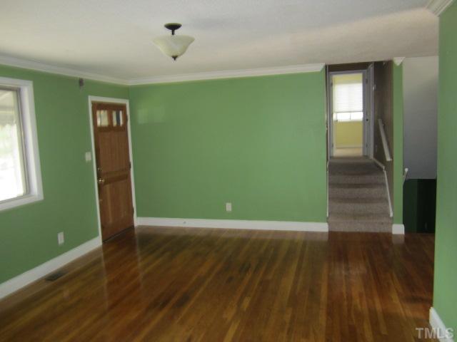 2421 Rock Quarry Road Raleigh, NC 27610 - Photo 3 of 10 a view of a room with wooden floor and entryway
