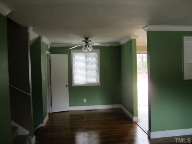 2421 Rock Quarry Road Raleigh, NC 27610 - Photo 5 of 10 an empty room with wooden floor chandelier and windows