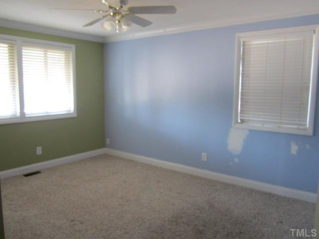 2421 Rock Quarry Road Raleigh, NC 27610 - Photo 7 of 10 an empty room with a window and a fan