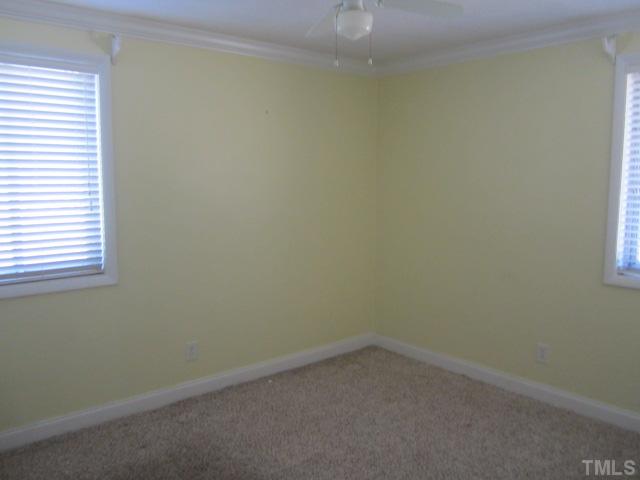2421 Rock Quarry Road Raleigh, NC 27610 - Photo 8 of 10 an empty room with a window