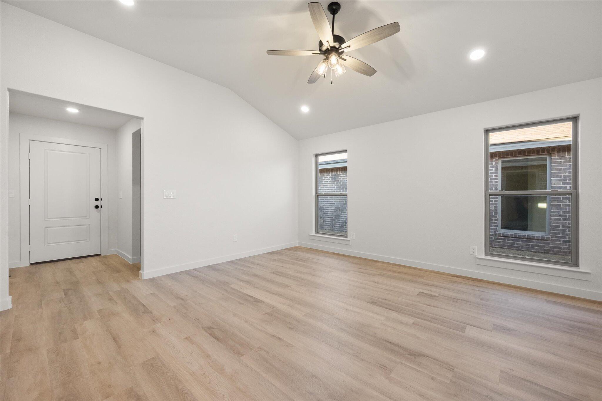 3113 140th Street Lubbock, TX 79423 - Photo 5 of 22 wooden floor in an empty room with a window