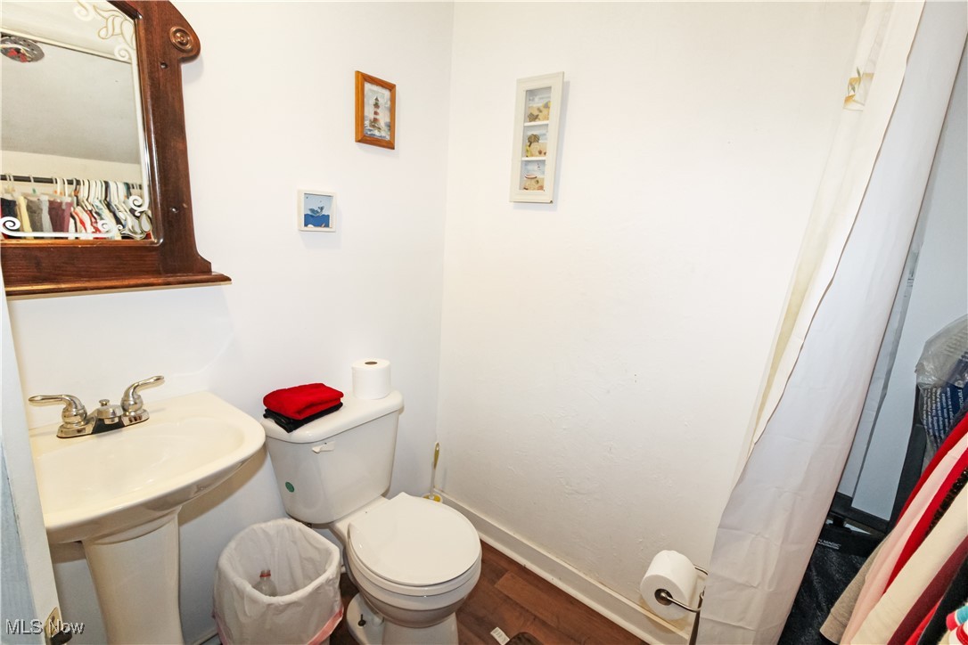 1120 Gypsum Road Gypsum, OH 43433 - Photo 6 of 20 Full bathroom with wood finished floors and toilet