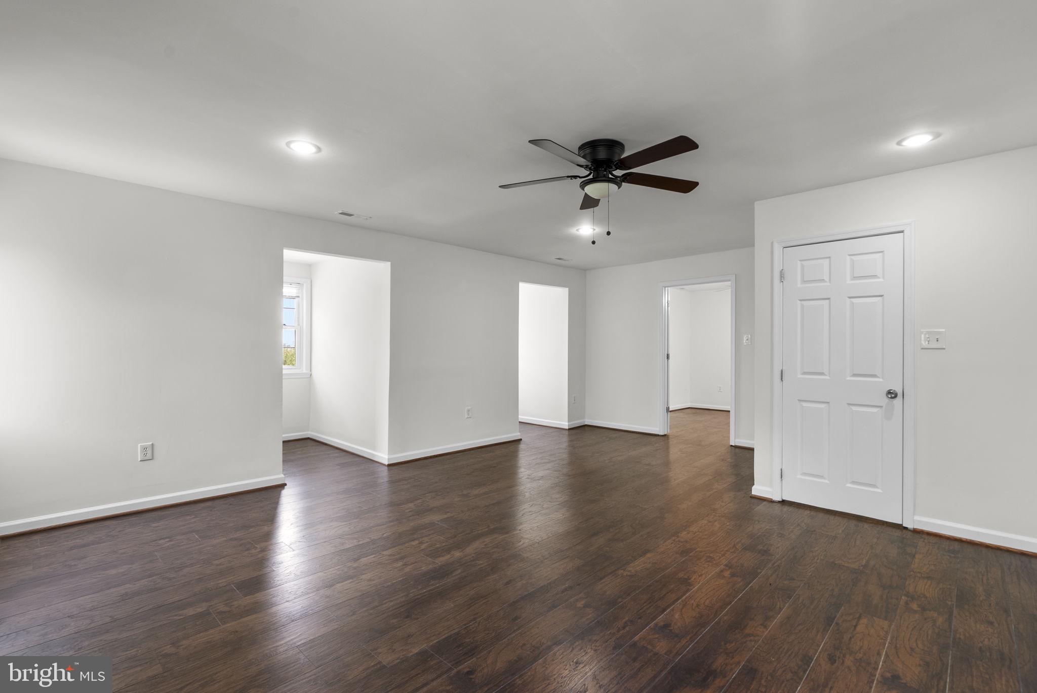 24000 Clarksburg Road Clarksburg, MD 20871 - Photo 25 of 60 a view of an empty room with wooden floor and a ceiling fan