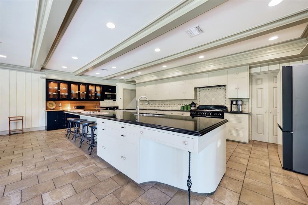 1901 Rose Pointe Athens, TX 75752 - Photo 14 of 37 Spacious kitchen featuring a large central island with a sink and seating, white cabinetry, integrated range, tile flooring, and coffered ceilings with recessed lighting