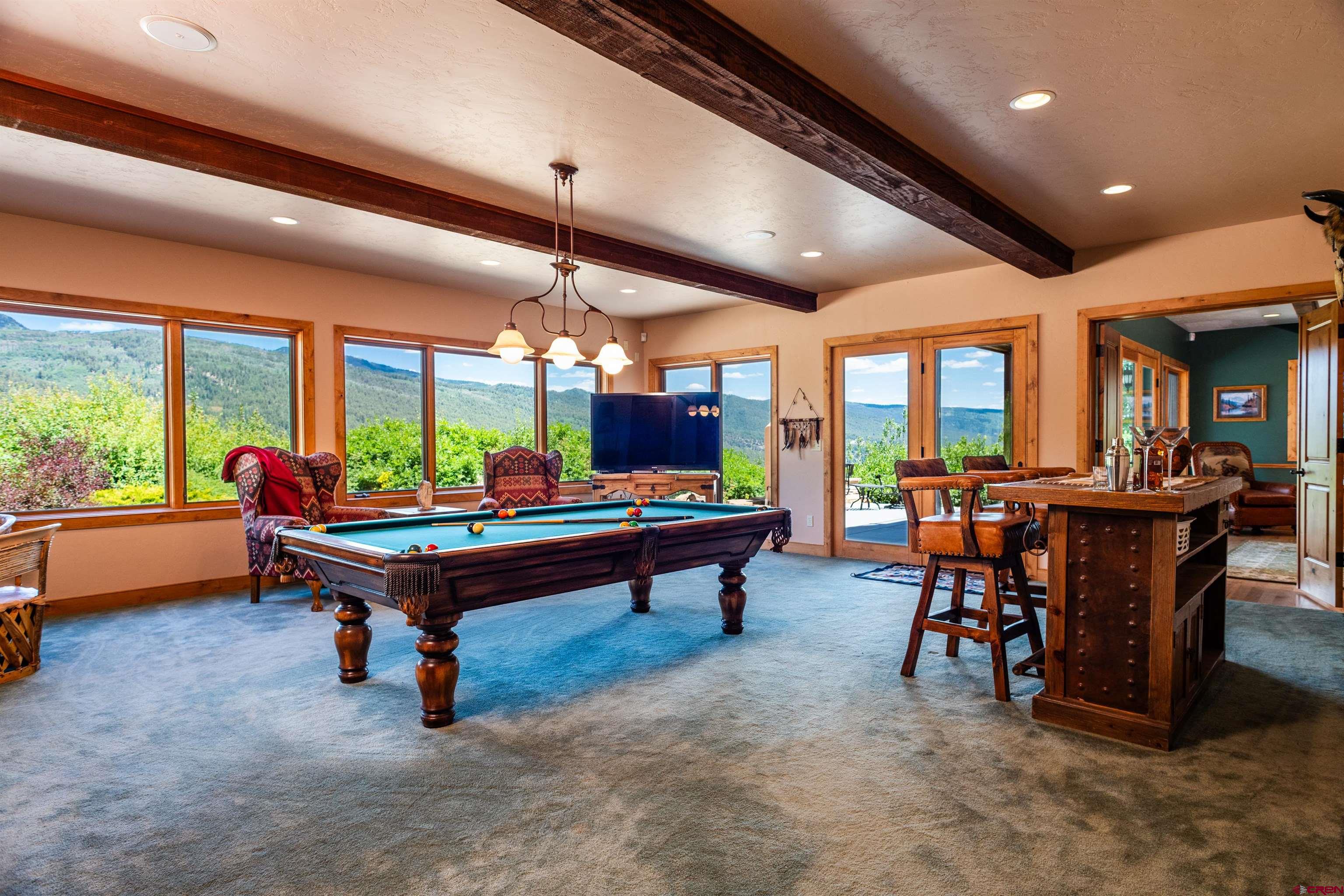 2550 Destination Ranch Road Durango, CO 81301 - Photo 15 of 45 a living room with furniture a pool table and a large window
