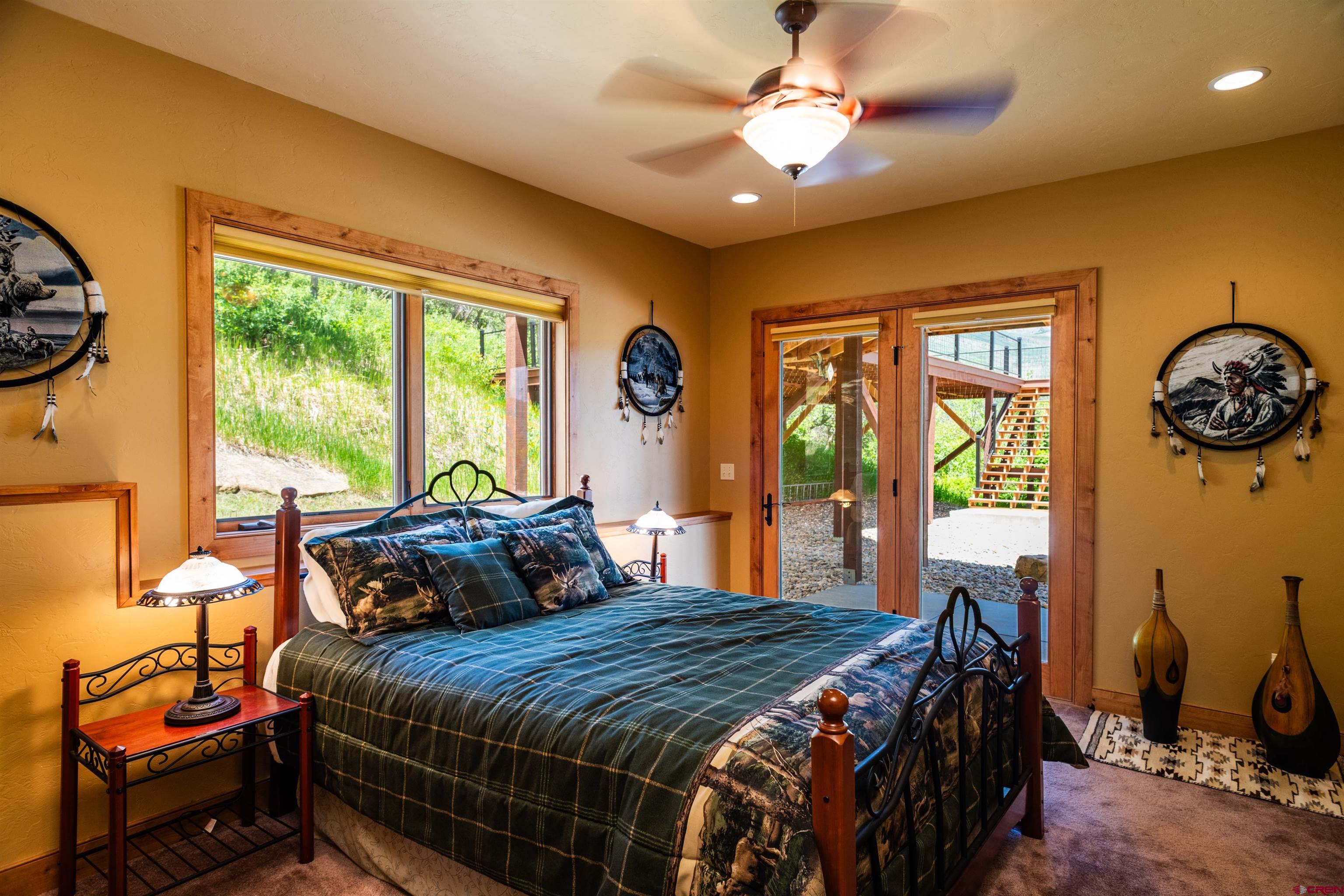 2550 Destination Ranch Road Durango, CO 81301 - Photo 39 of 45 a bedroom with a bed and a chandelier