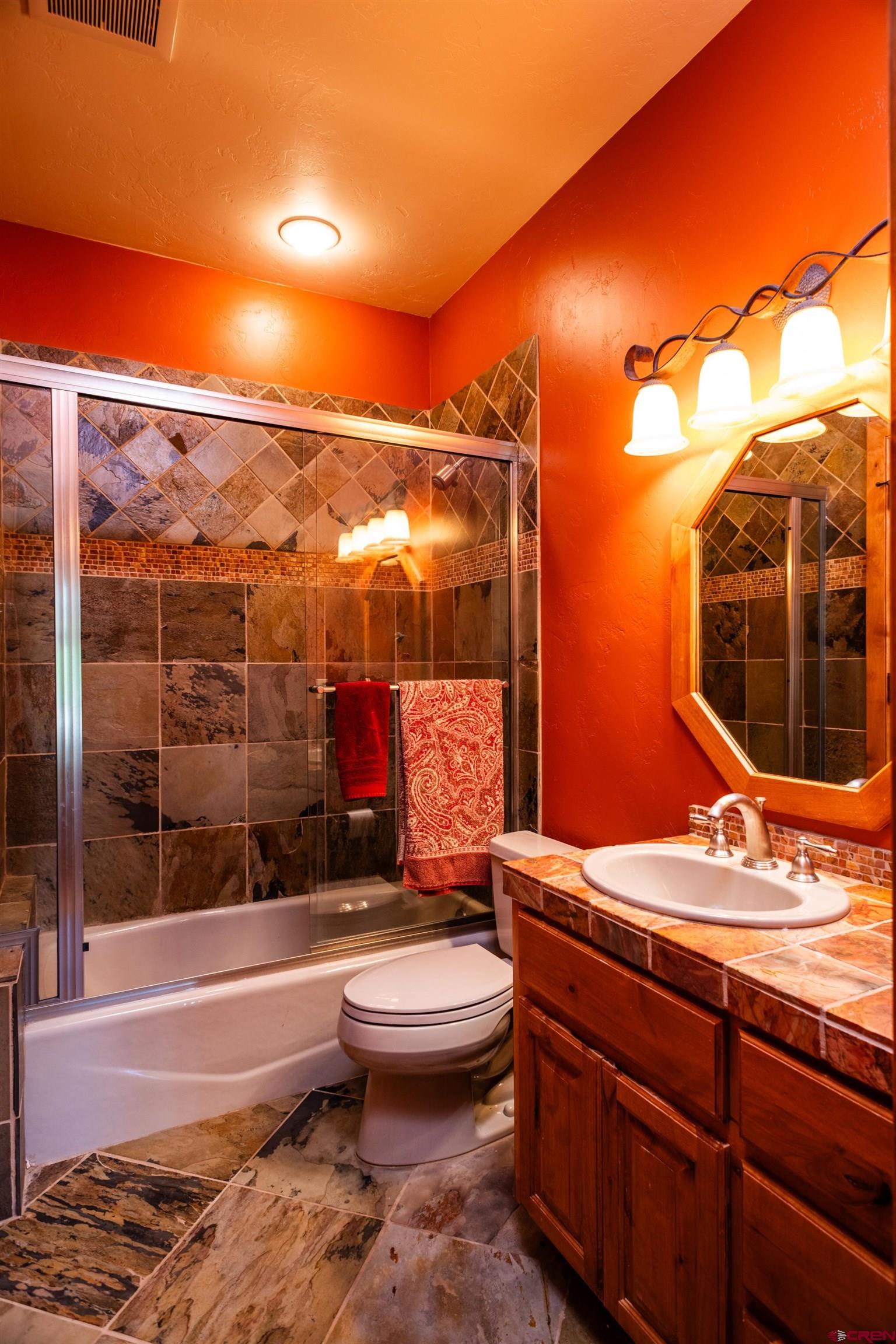 2550 Destination Ranch Road Durango, CO 81301 - Photo 40 of 45 a bathroom with a granite countertop sink toilet and shower