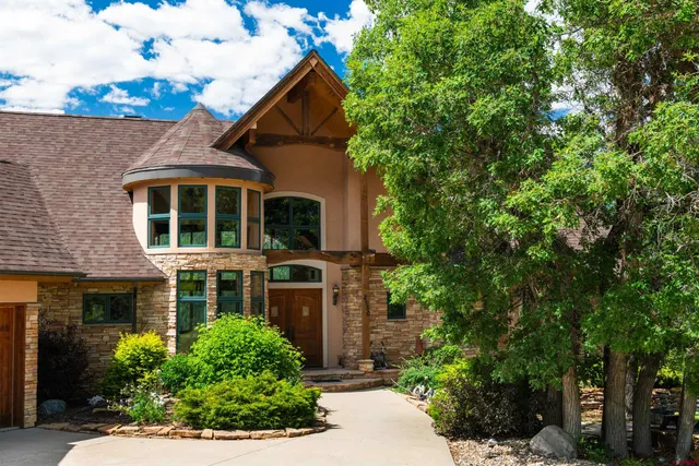 a living room with fireplace furniture and a large window