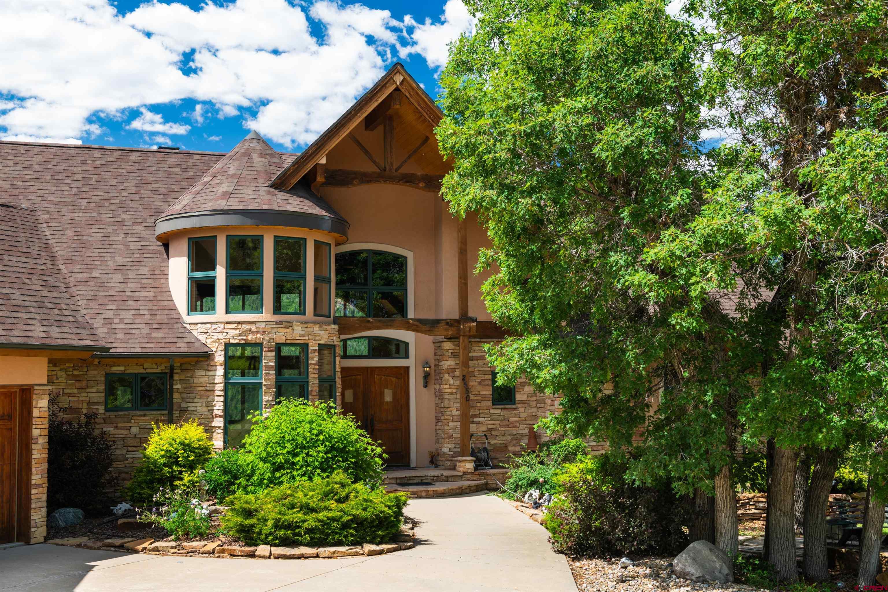 2550 Destination Ranch Road Durango, CO 81301 - Photo 4 of 45 a front view of a house with a yard