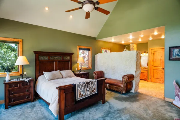 a living room with furniture a rug and a large window