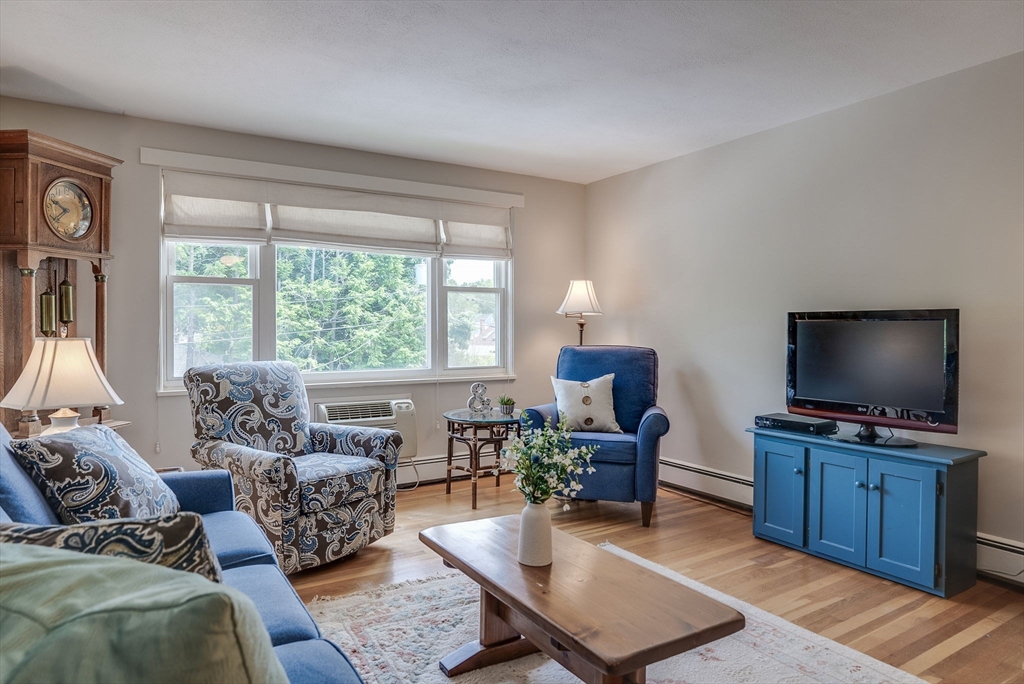 36 Whitman Road, Unit 24 Waltham, MA 02453 - Photo 3 of 14 a living room with furniture and a flat screen tv