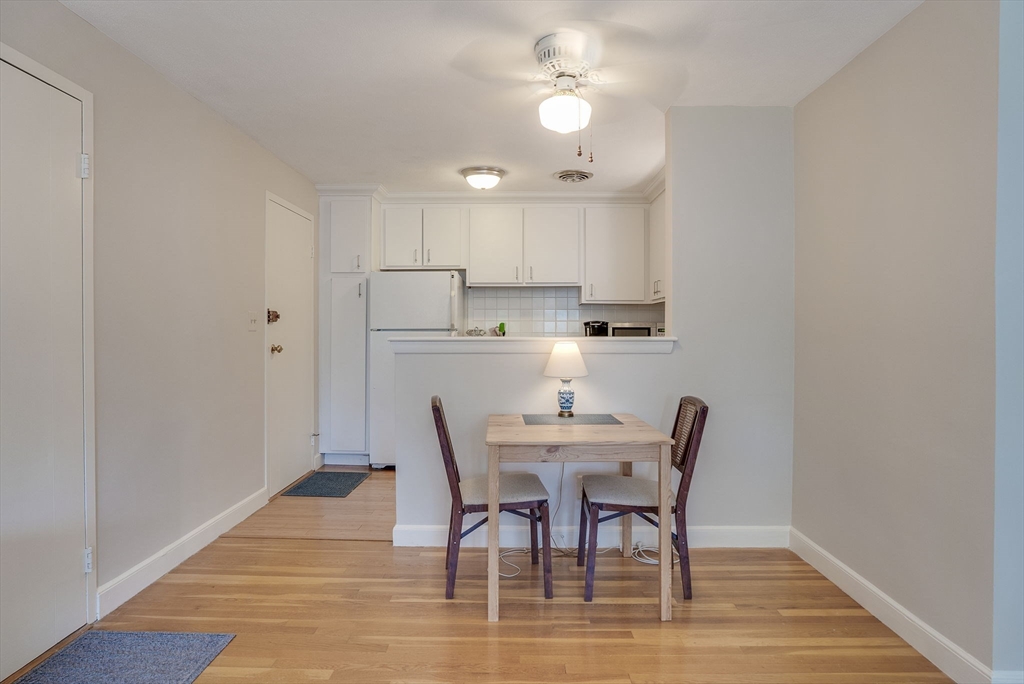 36 Whitman Road, Unit 24 Waltham, MA 02453 - Photo 5 of 14 a view of a dining room with furniture and wooden floor
