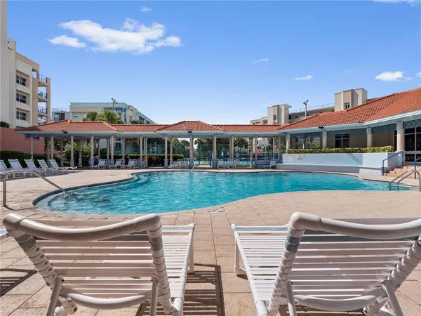 a view of swimming pool and a yard in front of the house