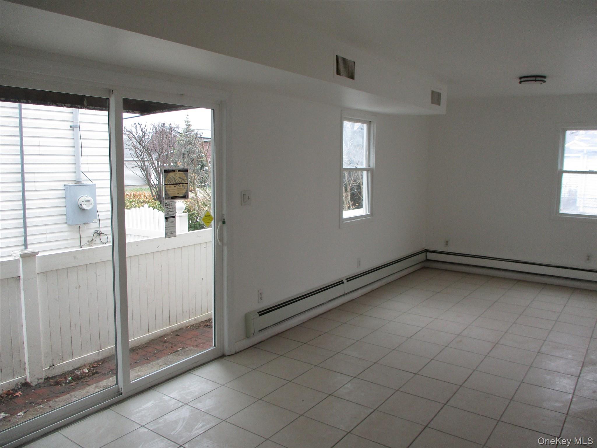 94 Roger Avenue Inwood, NY 11096 - Photo 12 of 19 a view of an empty room and window