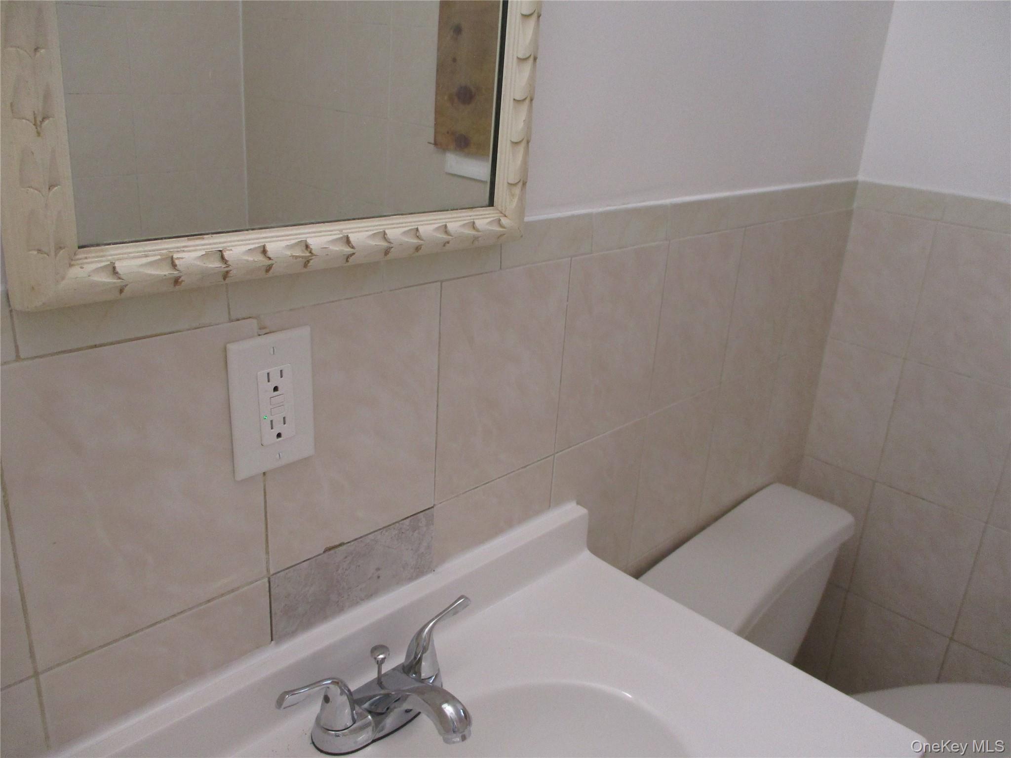94 Roger Avenue Inwood, NY 11096 - Photo 4 of 19 a bathroom with a sink and toilet