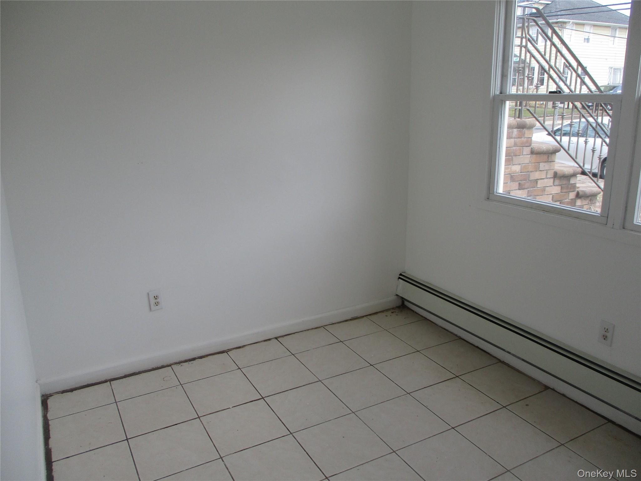 94 Roger Avenue Inwood, NY 11096 - Photo 8 of 19 an empty room with windows
