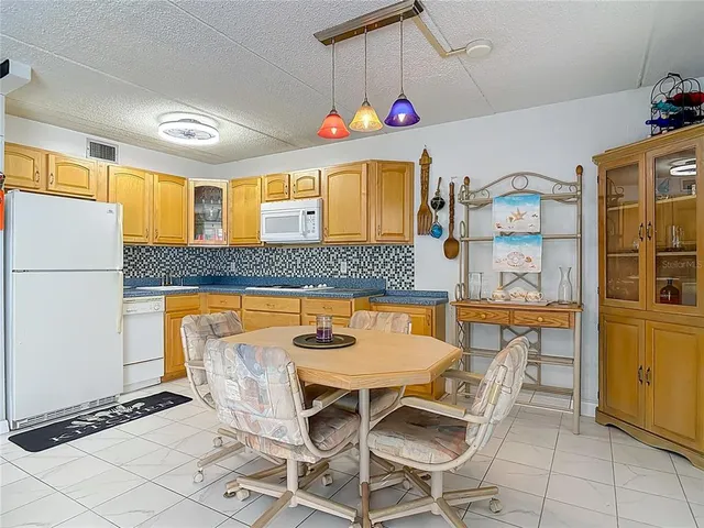 a dining room with granite countertop furniture and large windows