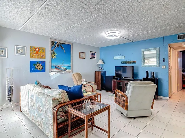 a work room with furniture a flat screen tv and a window