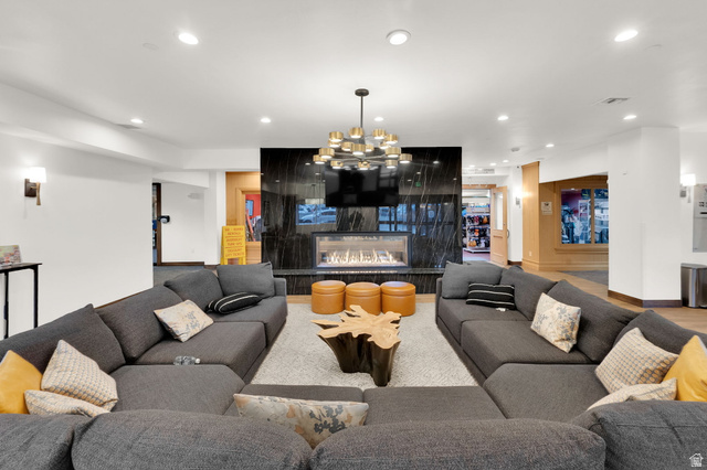 50 Shadow Ridge Road, Unit 4209 Park City, UT 84060 - Photo 24 of 50 Recessed lighting illuminates a modern fireplace with a dark stone surround