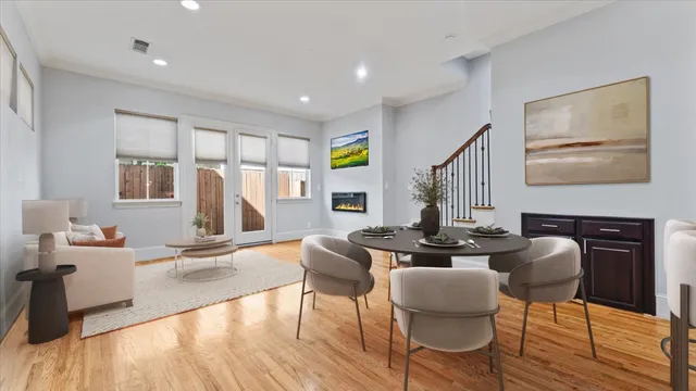 a living room with fireplace furniture and a wooden floor