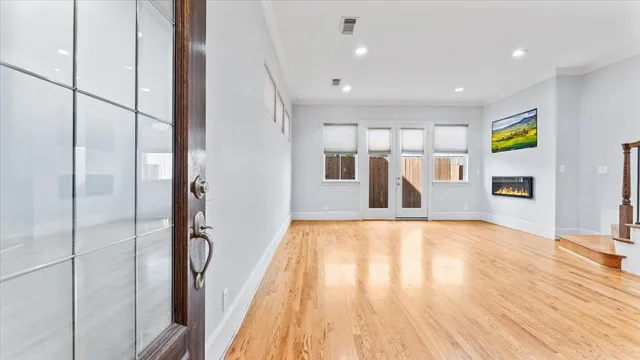 a view of a hallway with wooden floor