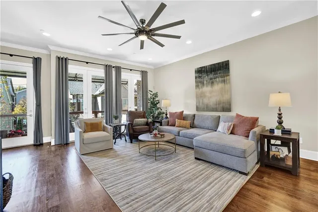 a living room with furniture and a wooden floor