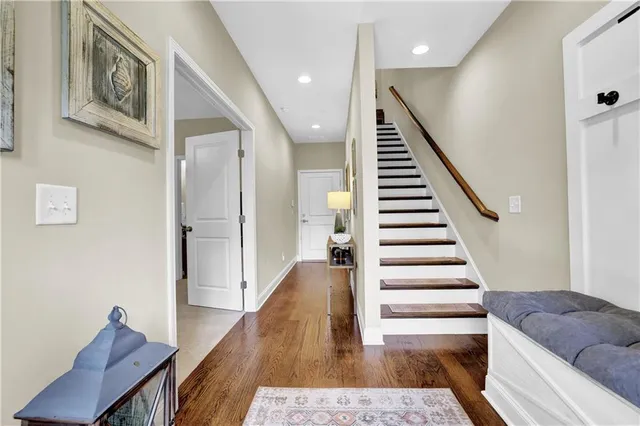 a view of entryway and hall with wooden floor