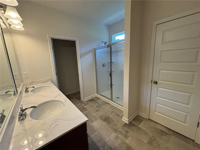 a bathroom with a glass shower door