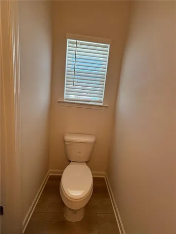 a view of a big house with a big yard and large trees