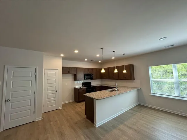 a view of kitchen with a sink and a large window