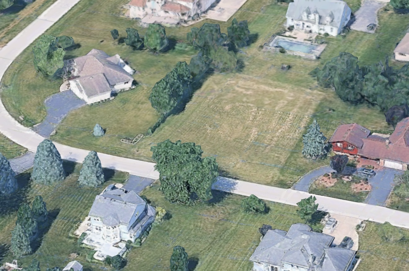 an aerial view of a house with outdoor space