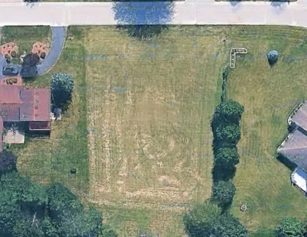 an aerial view of a houses with yard